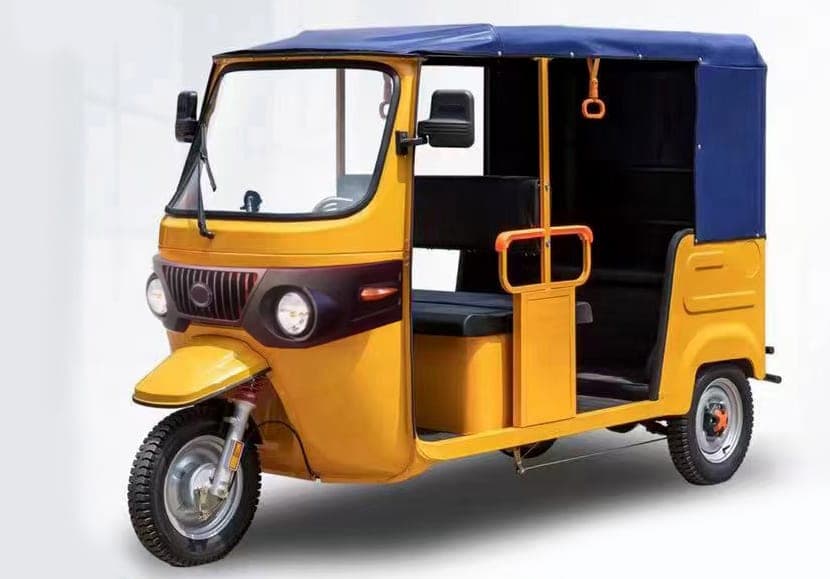 Yellow electric tuk-tuk auto-rickshaw passenger tricycle with canopy roof